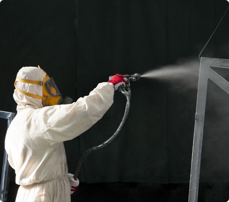 Technician spray-applying polyurea coating