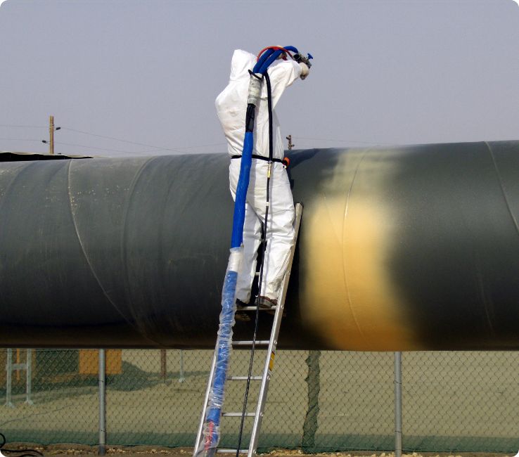 Industrial coatings being applied to a pipeline
